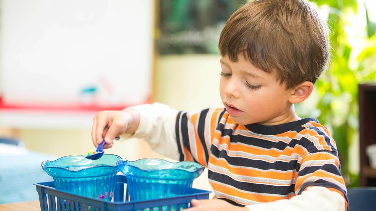 Little boy learning at Children's Magnet Montessori school.