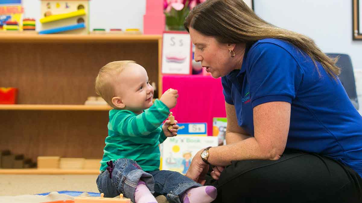 Teacher with child at infant daycare